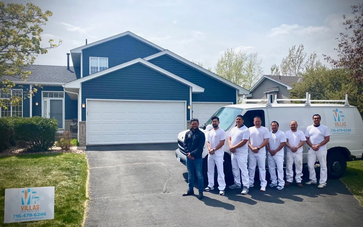 Andres Villa and the Villa's Pro Painting crew in whites beside the company van