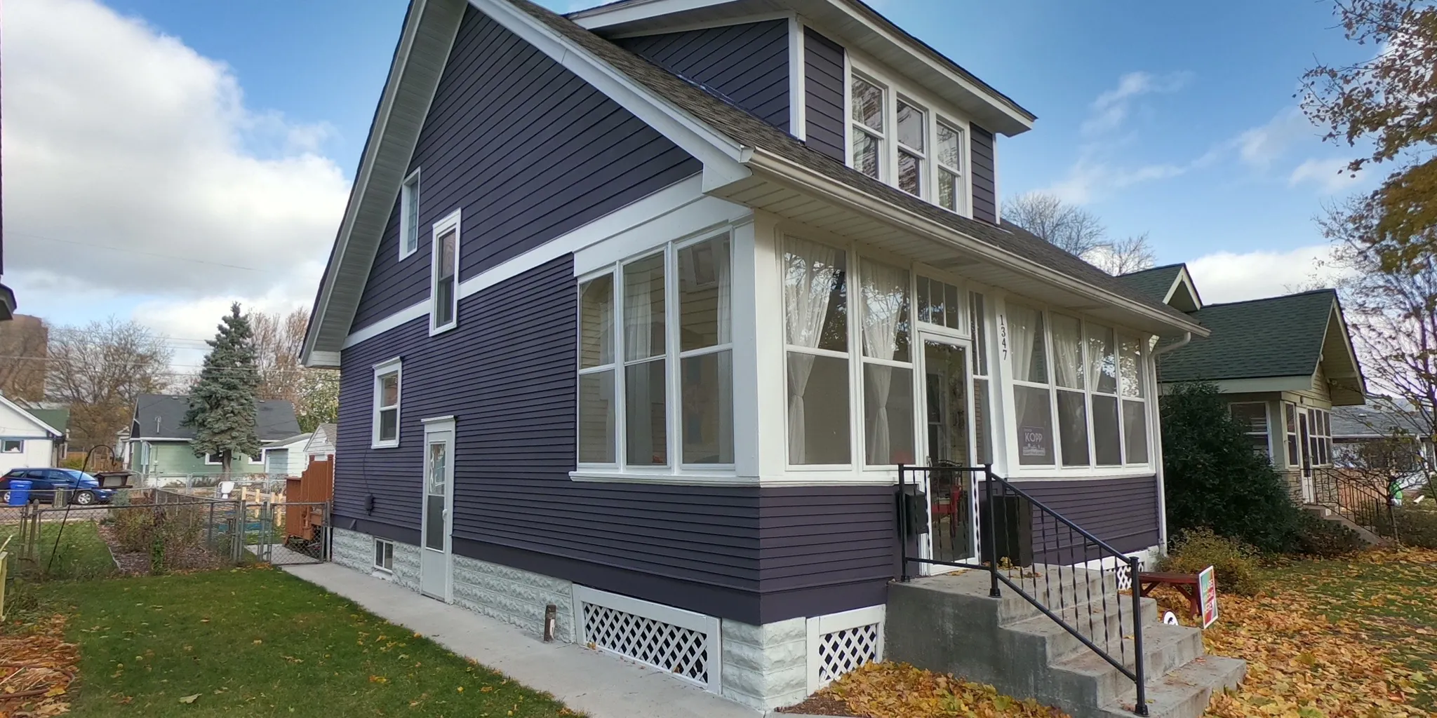 A two-storey house repainted deep navy with crisp white trim by Villa's Pro Painting